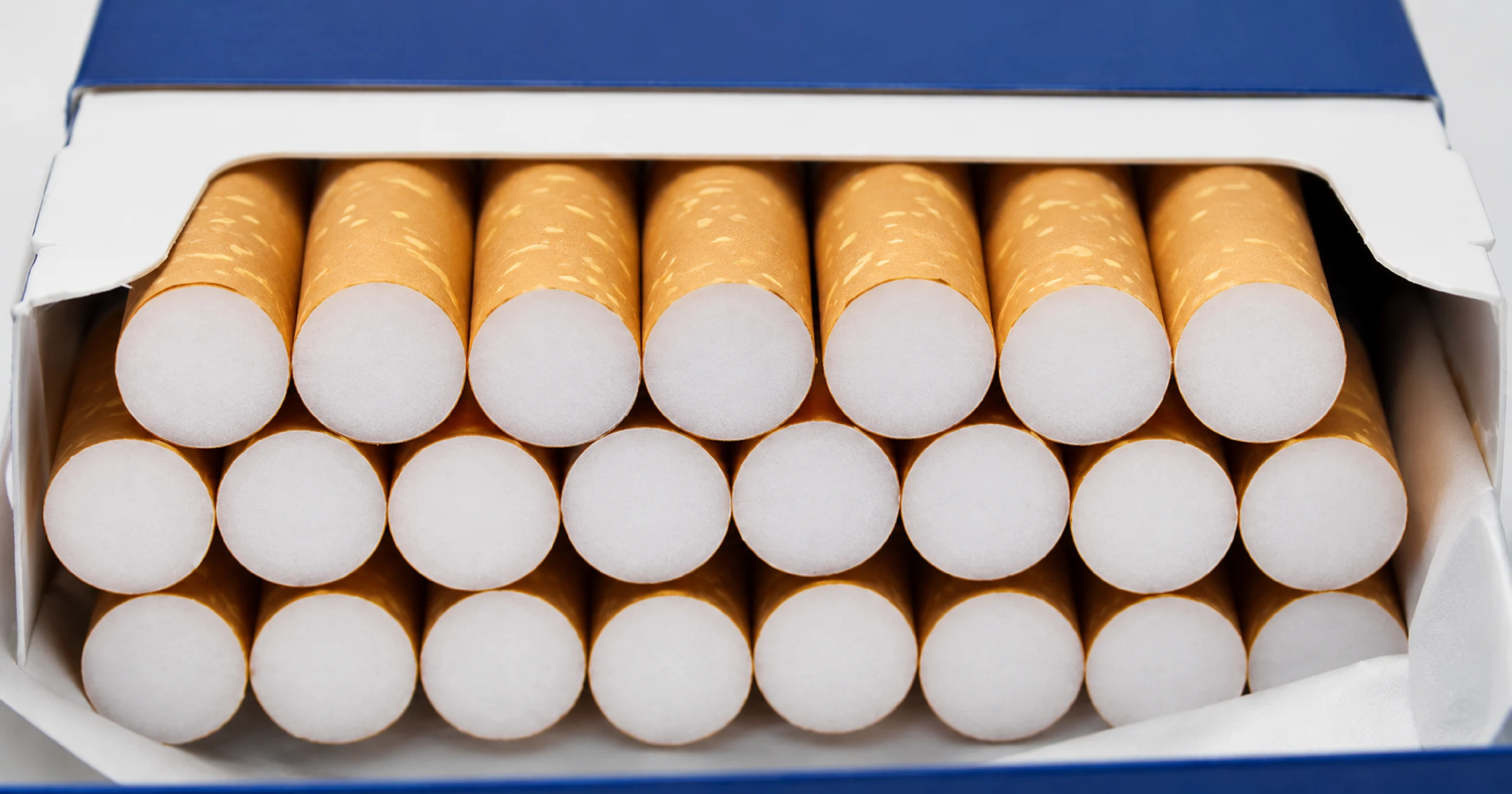 Open a blue-and-white cigarette pack filled with cigarettes.